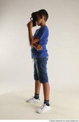 TIMBO STANDING POSE WITH GUN